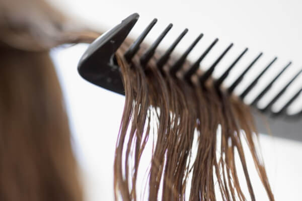 How to detangle a wig: Use wide tooth-comb to brush out big knots