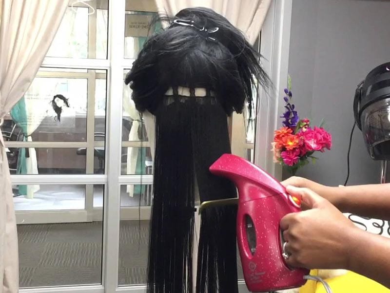 Use portable steamer to straighten synthetic wig